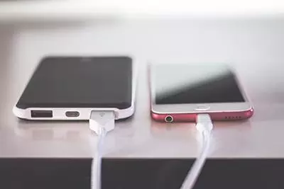 Phones charging on a table