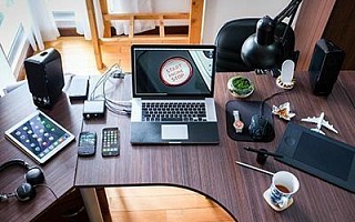 A photo of many electronic devices on a desk