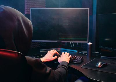 A man with a hoodie using a PC