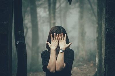 Woman with hands covering her eyes