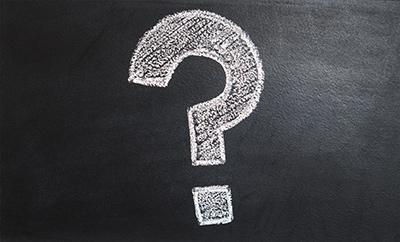 A chalk question mark on a blackboard
