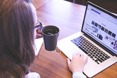 A woman using a website on a laptop