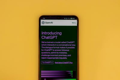 A mobile phone with the ChatGPT homepage open in a browser