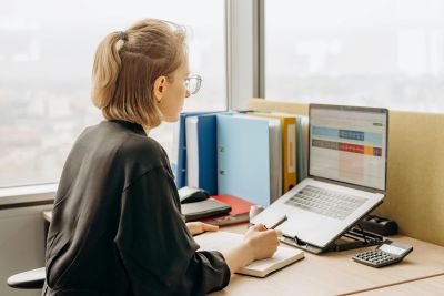 Woman looking at a spreadsheet on her laptop