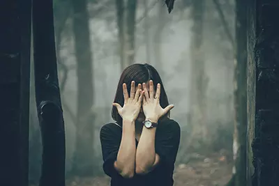 A woman hiding her face