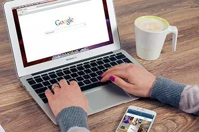 Someone using Google on a laptop