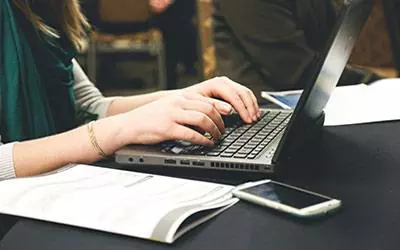 Someone working on a laptop