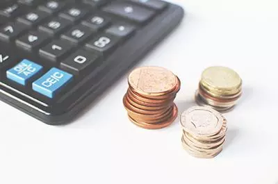 Coins next to a computer keyboard