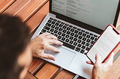 Man using laptop and mobile at the same time