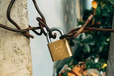 Padlock on rusting chains