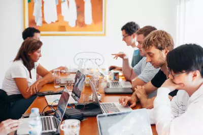 A group of people using laptops