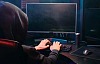 A man with a hoodie using a PC